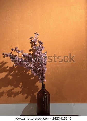 The modern flower bottle and the orange wall art deco