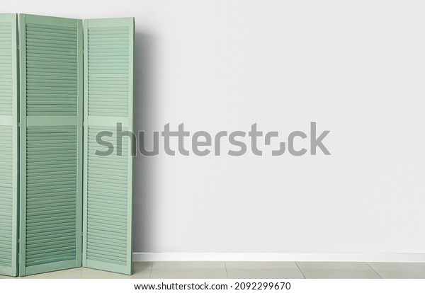 Modern folding screen near\
light wall