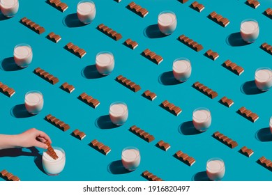 Modern food pattern of chocolate bars and milk on a blue background