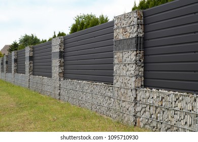 A Modern Form Of House Fencing. Gabions, Steel Galvanized Nets Filled With Split Stone