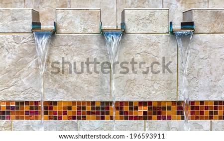 Modern fountain detail. Waterfall drop design with decorative glass mosaic tile feature.