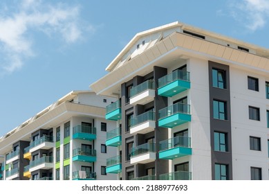 Modern freshly built apartment buildings on a sunny day with blue sky. Facade of a modern apartment building. - Shutterstock ID 2188977693