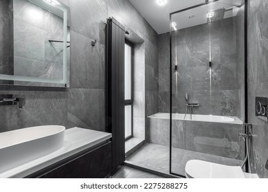 Modern furnished bathroom dark grey interior design with granite tiles