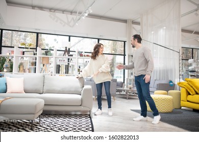 Modern Furniture. Man And Woman Discussing Furniture Models In A Modern Furniture Shop