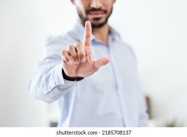 Modern, future and futuristic business man pointing his finger up pressing an empty virtual touchscreen. Closeup portrait of a corporate professional male touching an invisible screen or in an - Powered by Shutterstock