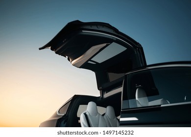 Modern and futuristic SUV car vertical door. Expensive and luxury crossover with falcon wings style door 