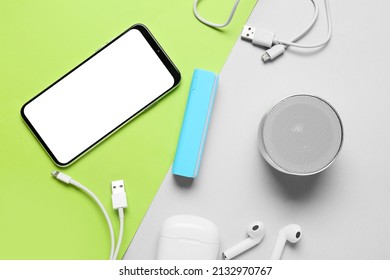 Modern gadgets with blue power bank on color background - Shutterstock ID 2132970767