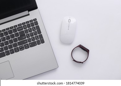 Modern Gadgets. Laptop With Pc Mouse, Smart Bracelet On White Background. Top View. Flat Lay