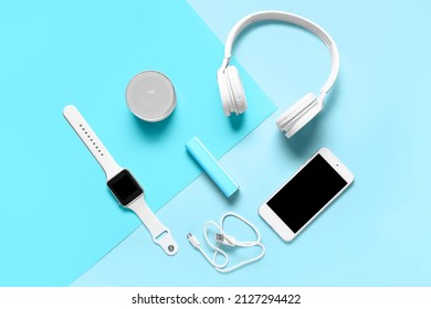Modern gadgets with power bank on blue background
