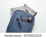 Modern gadgets For work and study. Backpack with laptop, notebook, external hard drive, pc mouse and Graphics tablet on white background. Top view. Flat lay