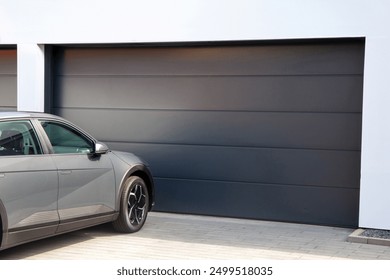 Modern garage door (sectional door) with car parked in front