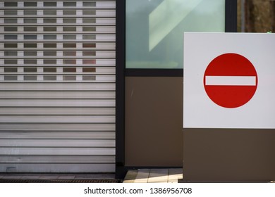 A modern garage exit with a large passage forbidden sign.