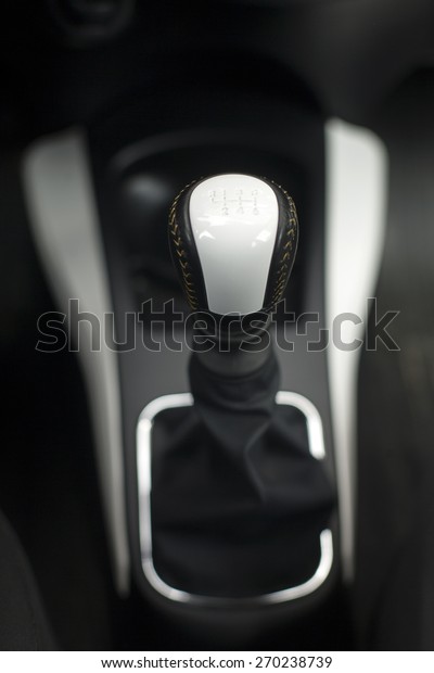 Modern gear shift lever in a luxury car,soft\
focus,close up