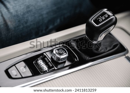 Modern gearbox car. Electronic handbrake button. Gear shift stick into P position, (parking) symbol in automatic transmission. Start stop button, drive mode selection. Top view.