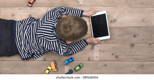 Modern Generation. Kid Playing On Ipad