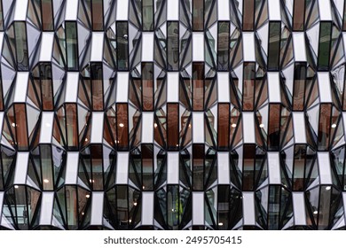 Modern Geometric Glass Facade of Urban High-Rise Building with Symmetrical Architectural Patterns and Reflections - Powered by Shutterstock