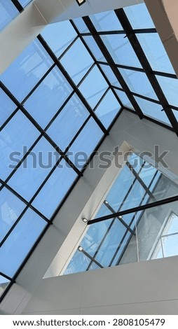 Modern Glass Atrium With Triangular , Achitecture and Skylight Ceiling In Contemporary Building