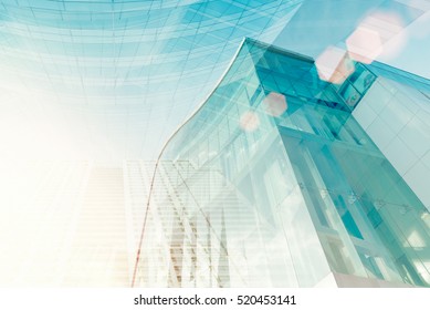 Modern Glass Building With Sun Flare. Soft Focus Of City For Abstract Background.