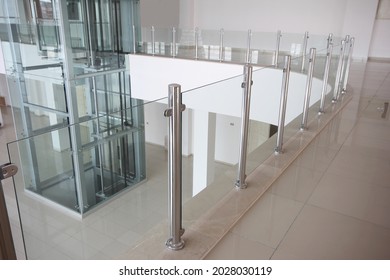 Modern glass elevator and glass railings
