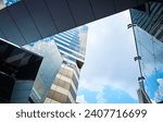 Modern glass exterior of business office building against sky from low angle view at Siam square in Bangkok, Thailand.