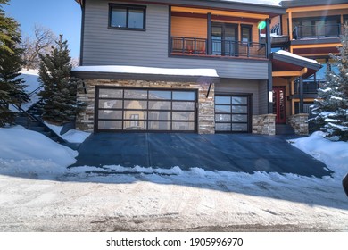 Modern Glass Garage Door Of Home In Park City Utah Amid Snowy Land In Winter