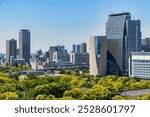  Modern glass skyscrapers seen from the upper floors of Osaka Castle, Japan.