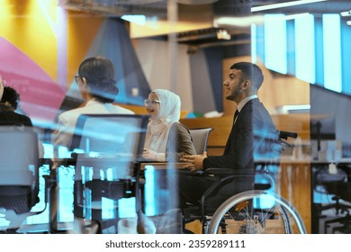 In a modern glass startup office, a wheelchair-bound director leads a successful meeting with colleagues, embodying inclusivity and teamwork. - Powered by Shutterstock