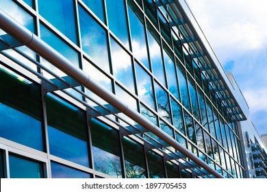 Modern Glass And Steel Office Building With Reflections In The Window And Diminishing Perspective. 