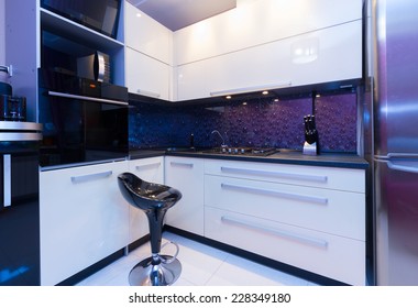 Modern Glossy Kitchen With Black Empty Chair