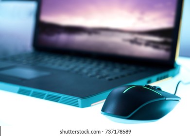 Modern Glowing Mouse Connected To Gaming Laptop 