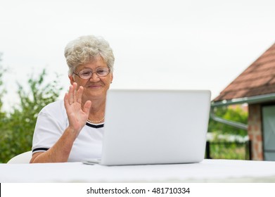 Modern Grandma Talking On The Skype With Family