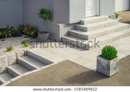 Modern granite external staircases and entrance to a single-family home