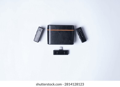 Modern graphics drawing tablet with computer accessories arranged in a clean flat lay composition on a white background. This minimal technology workspace includes a pen tablet, wireless remote, USB flash drive, and USB receiver, making it ideal for concepts related to digital art, graphic design, office productivity, creative work, remote working, technology, and modern business presentations. The isolated background provides generous copy space for advertising, web design, editorial use, and commercial marketing materials.