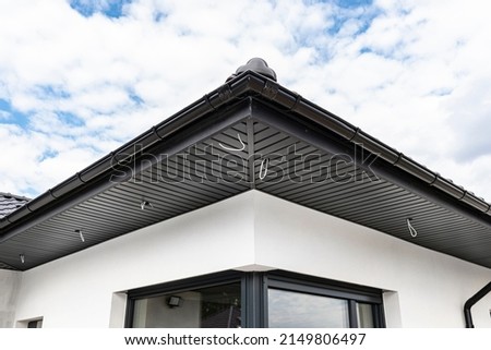A modern graphite roof lining is attached to the trusses, visible cables and holes for LED lights.