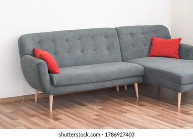 Modern Gray Couch With Red Pillows On Wooden Tiled Floor - Office Furniture