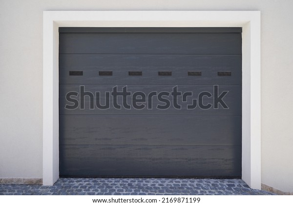 Modern\
gray ventilated garage door. Automatic garage\
door