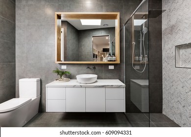 Modern grey designer bathroom with herringbone shower tiling - Shutterstock ID 609094331