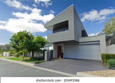 Modern Grey House Front With Large Garage Port And Driveway