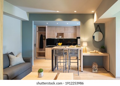 Modern Grey And Wooden Interior Of Small Studio Apartment. Front View Of Hotel Flat Room Witn Kitchen, Living, Bedroom In Single Space