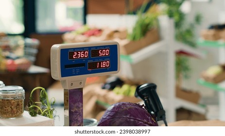 Modern grocery store scale in empty shop used in small business organic farming, freshly harvested produce. Sustainable zero waste supermarket with natural organic fruits and vegetables. Close up.