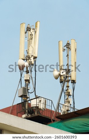 Modern GSM antennas on a high tower against the background of a blue sky for transmitting a 5g signal are dangerous to health. Radiation pollution of the environment through cell towers.