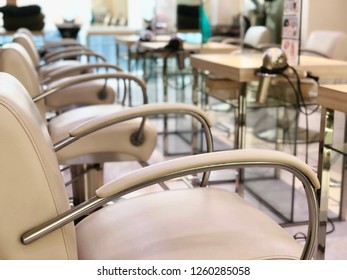 Modern Hair Salon Interior. Focus Front Of Leather Chair And Blurred Behind Background.