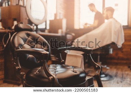 Modern hairdresser and hair salon, barber shop for men. Barbershop armchair vintage color background.
