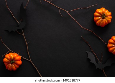 Modern Halloween background with pumpkins, bats, decorations. Halloween party invitation card mockup. Flat lay, top view, copy space.