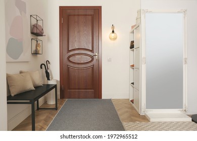 Modern hallway interior with stylish furniture and mirror