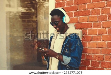 Similar – Young happy black man is listening to music