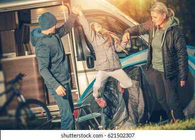 Modern Happy Family Camping. Motorcoach RV Camper Camping. Happy Family With Child.