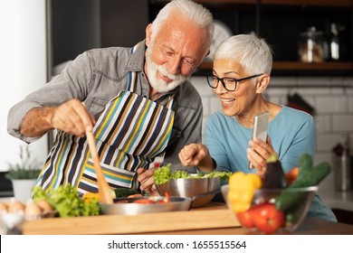 Modern and harmonious couple prepares their favorite recipe and shares with their friends via video call, fun and domestic life of pensioner - Shutterstock ID 1655515564