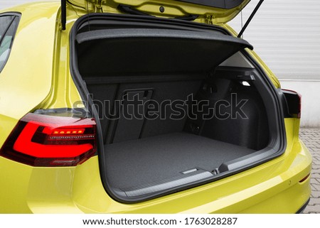 Modern hatchback car with open trunk. The car boot is open for luggage. The car prepared for a drive and waited after the passengers. A lot of space for coffers and bags. Ready for a trip