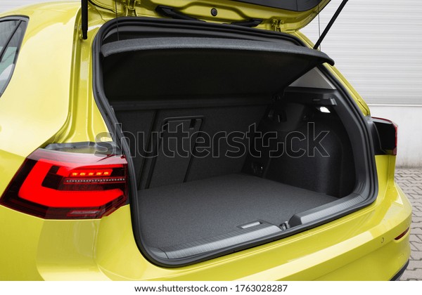 Modern\
hatchback car open trunk. The car boot is open for luggage. Car\
prepared for a drive and waiting after passengers\
